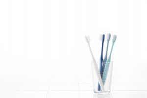 image of toothbrushes in a glass
